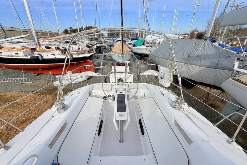 Slide: The Image of 2001 Catalina 380 sailboat in a marina, surrounded by other docked boats. - 21