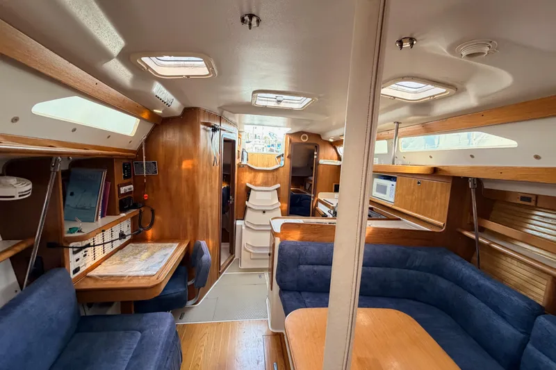 Slide: The Image of Interior of 2001 Catalina 380 sailboat with wood finish and blue seating. - 29