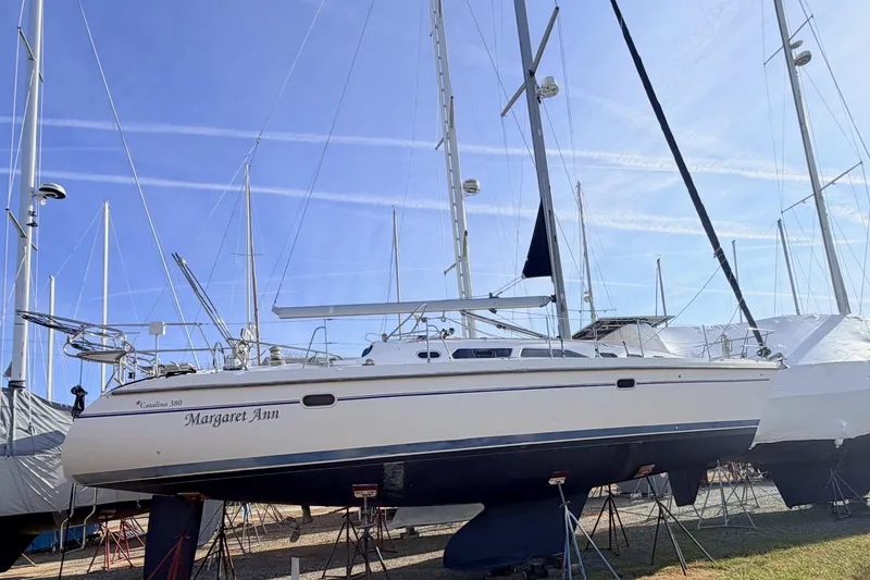 Slide: The Image of 2001 Catalina 380 sailboat "Margaret Ann" on stands in a marina under clear blue sky. - 3