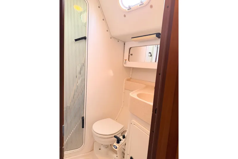 Slide: The Image of Compact bathroom in 2001 Catalina 380 sailboat with shower, toilet, and sink. - 33