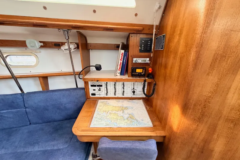 Slide: The Image of Navigation station in a 2001 Catalina 380 sailboat with chart and communication equipment. - 38
