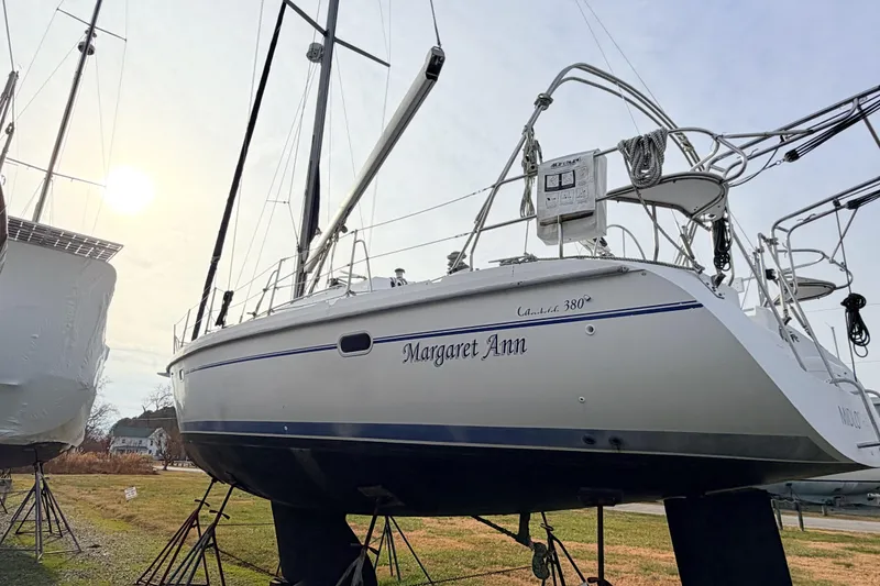 Slide: The Image of 2001 Catalina 380 sailboat named "Margaret Ann" on stands, sunlit background. - 4