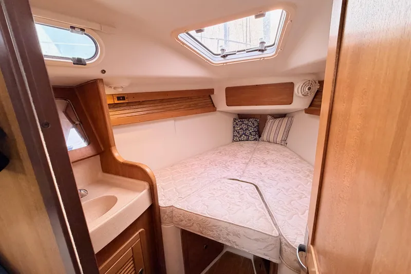 Slide: The Image of Cozy cabin interior of 2001 Catalina 380 sailboat with bed and porthole. - 40