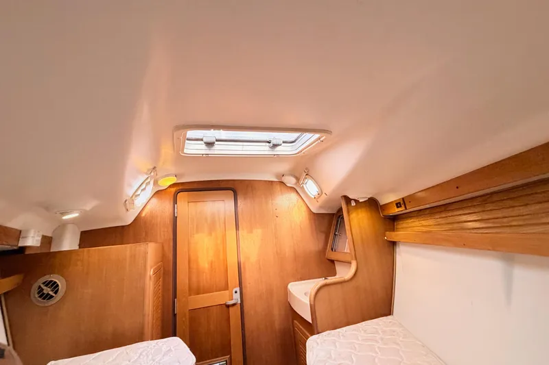 Slide: The Image of 2001 Catalina 380 cabin interior with wooden finish and twin beds. - 41