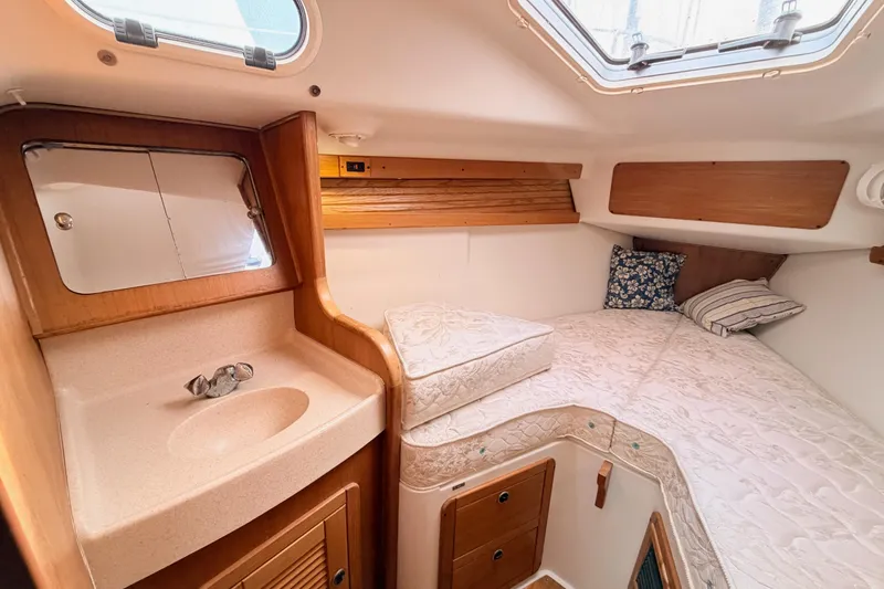 Slide: The Image of Cozy cabin interior of 2001 Catalina 380 sailboat with bed, sink, and storage. - 42