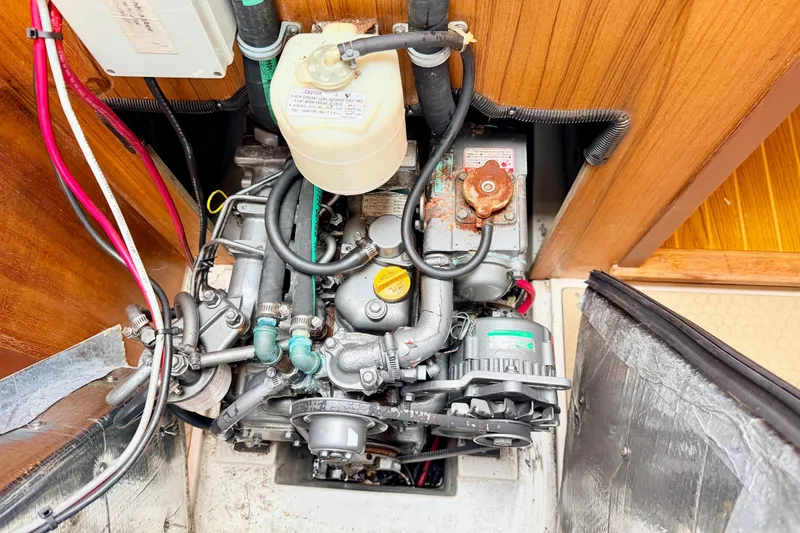 Slide: The Image of Engine compartment of a 2001 Catalina 380 sailboat, showing detailed mechanical components. - 45