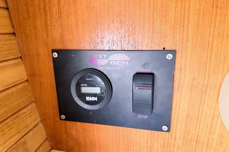 Slide: The Image of Control panel on a 2001 Catalina 380 sailboat with hour meter and start/stop switch. - 49