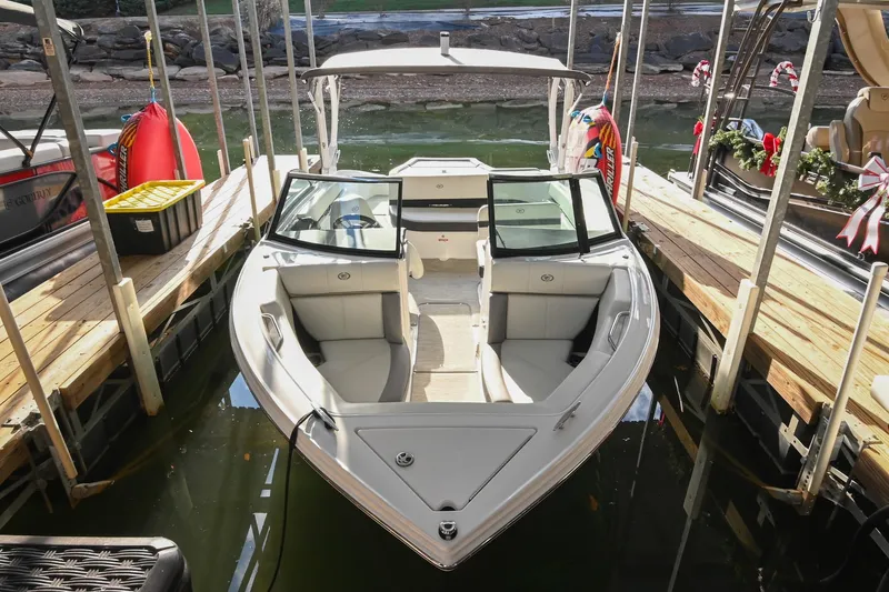 Slide: The Image of 2023 Cobalt CS22 boat docked, featuring sleek design and spacious seating. - 10