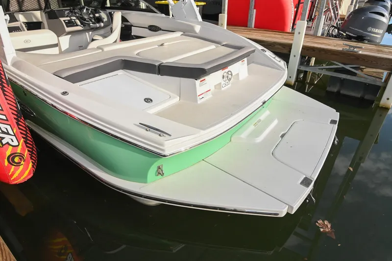 Slide: The Image of 2023 Cobalt CS22 boat docked, featuring sleek design and spacious seating. - 11