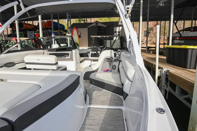 Slide: The Image of 2023 Cobalt CS22 boat interior with sleek seating and modern dashboard design. - 16