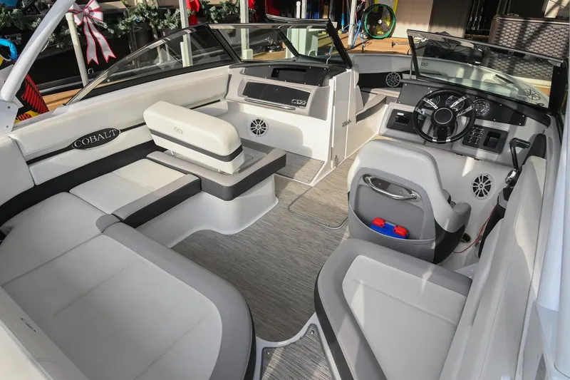 Slide: The Image of 2023 Cobalt CS22 boat interior with modern seating and steering console. - 17