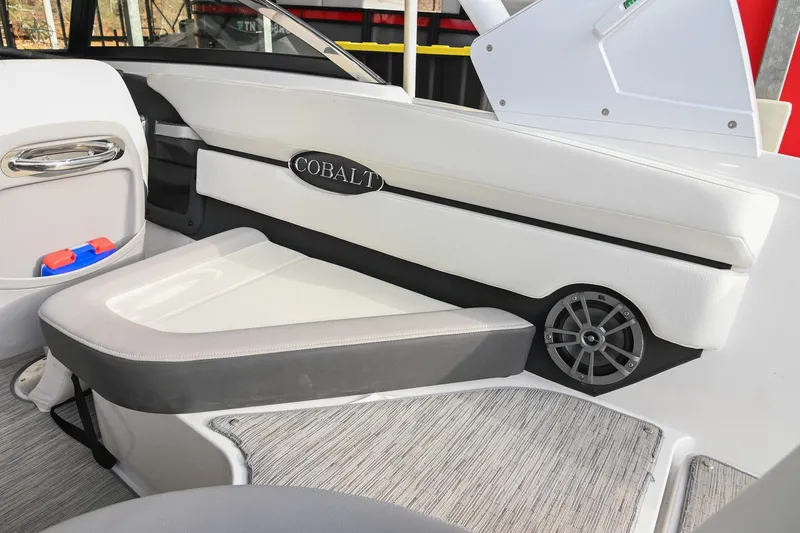 Slide: The Image of 2023 Cobalt CS22 boat interior with white seating and speaker detail. - 19