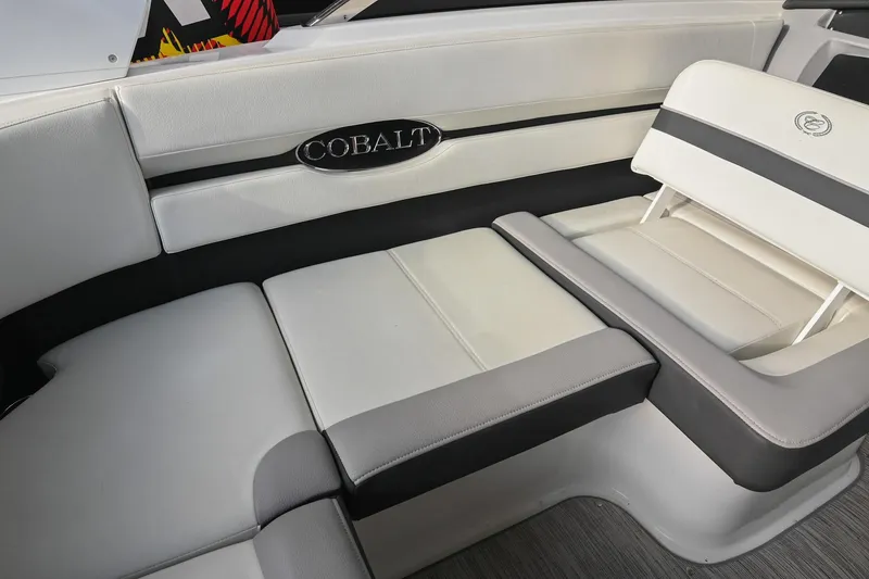 Slide: The Image of 2023 Cobalt CS22 boat interior with luxurious white and gray seating. - 23