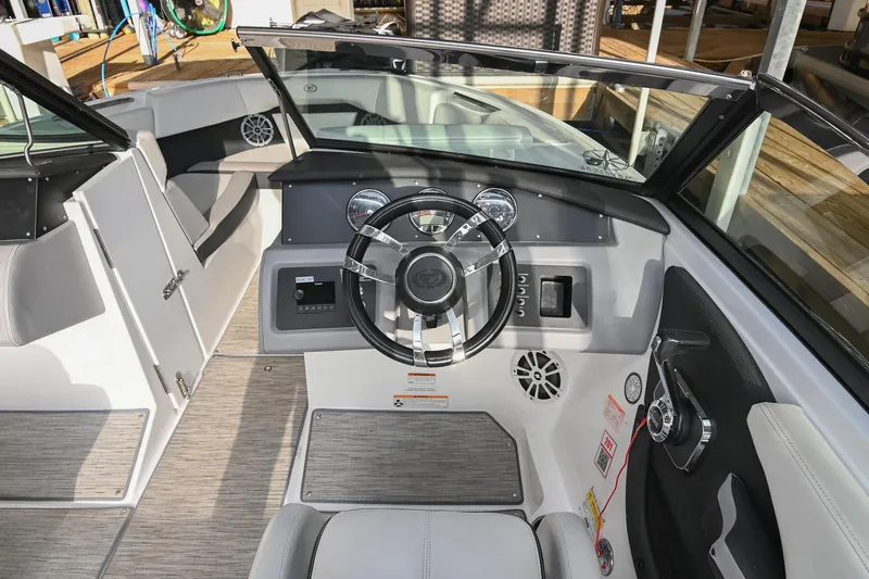 Slide: The Image of 2023 Cobalt CS22 boat interior with modern steering and dashboard design. - 30