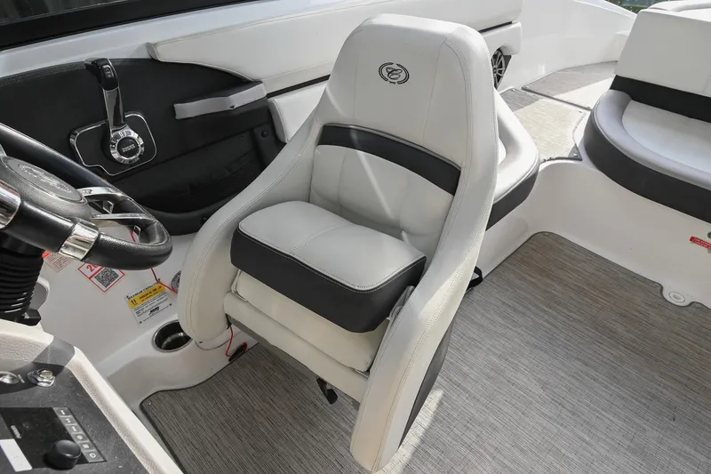 Slide: The Image of 2023 Cobalt CS22 boat interior with steering wheel and cushioned seating. - 35