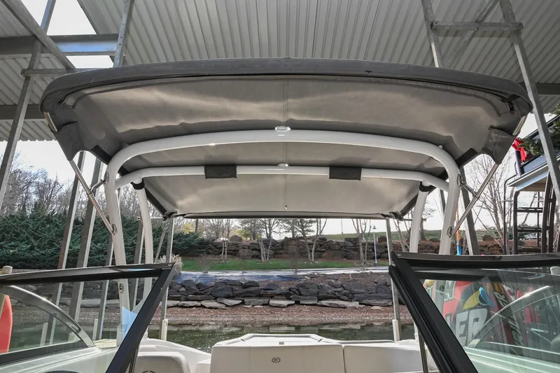 Slide: The Image of 2023 Cobalt CS22 boat with canopy under a dock, showcasing interior and exterior design. - 44
