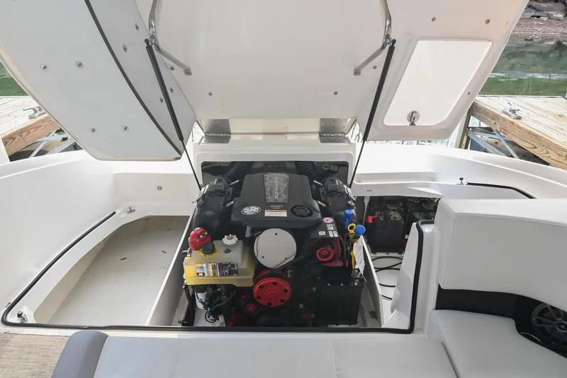 Slide: The Image of 2023 Cobalt CS22 boat engine compartment with open hatch, dockside view. - 45