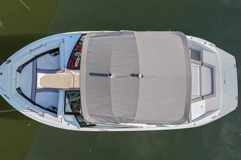 Slide: The Image of Top view of a 2023 Cobalt CS22 boat with a gray canopy on water. - 7