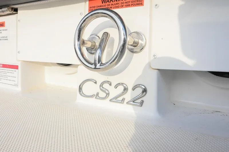 Slide: The Image of 2023 Cobalt CS22 boat emblem and warning labels on white surface. - 8
