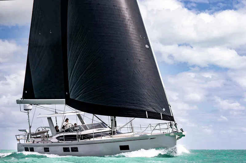 The Image of Manufacturer Provided Image: 2025 Hylas H57 yacht sailing on turquoise waters under a partly cloudy sky. - 0