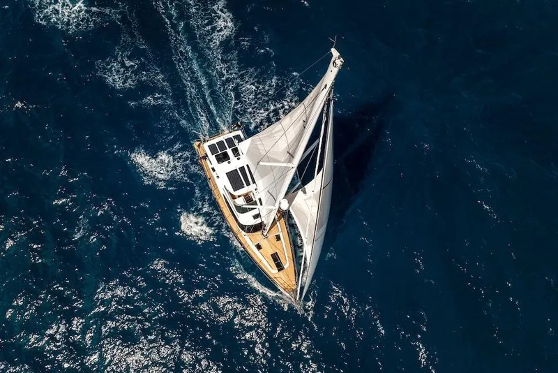 Slide: The Image of Aerial view of 2025 Hylas H57 yacht sailing on deep blue ocean waters. - 15