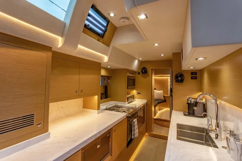 Slide: The Image of Manufacturer Provided Image: Luxurious interior of 2025 Hylas H57 yacht, featuring modern kitchen design and elegant lighting. - 31