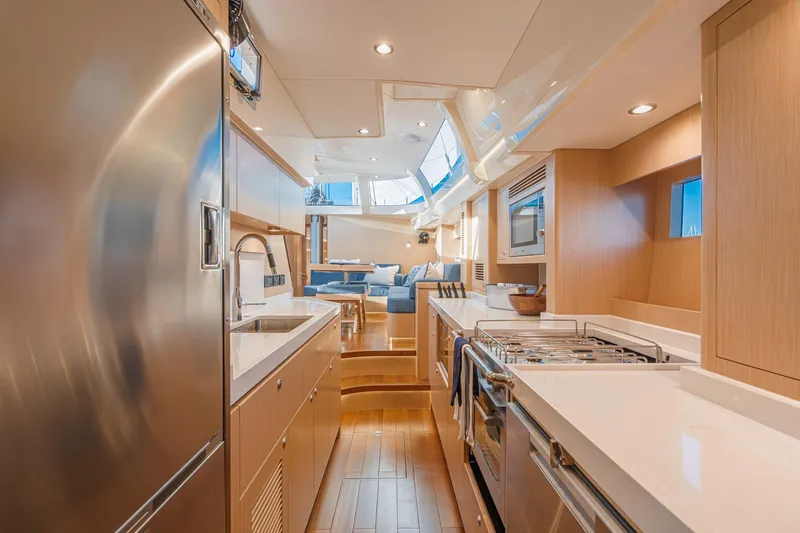 Slide: The Image of Luxurious interior of 2025 Hylas H57 yacht, featuring modern kitchen and seating area. - 32
