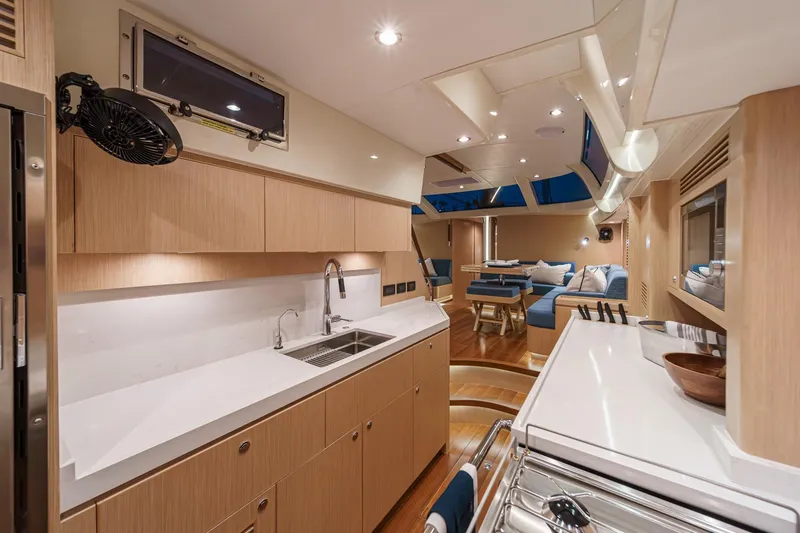 Slide: The Image of Luxurious interior of 2025 Hylas H57 yacht featuring modern kitchen and cozy seating area. - 34