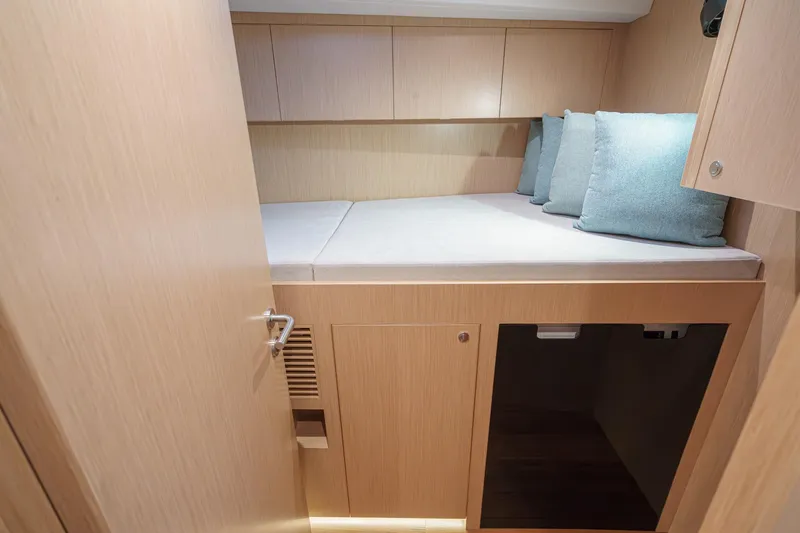 Slide: The Image of Cozy cabin interior of 2025 Hylas H57 yacht with light wood finish and cushions. - 46