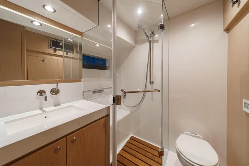 Slide: The Image of Luxurious bathroom in 2025 Hylas H57 yacht with modern fixtures and wooden accents. - 48