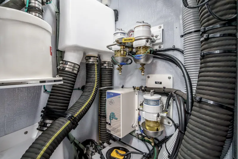 Slide: The Image of Engine room of 2025 Hylas H57 yacht with hoses and filtration systems. - 49