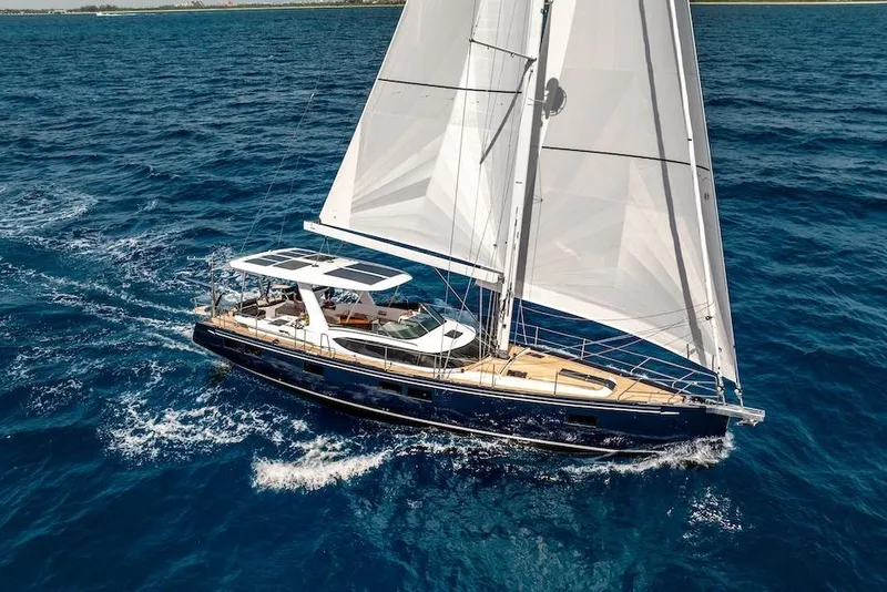 Slide: The Image of Sailing yacht Hylas H57 2025 gliding on open blue sea with full sails. - 7