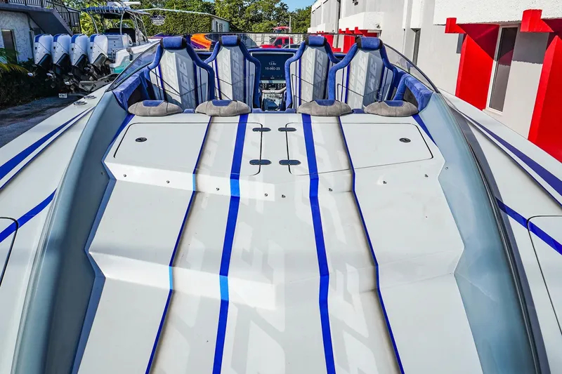 Slide: The Image of 2026 Statement 396 boat with sleek design and blue racing stripes. - 10