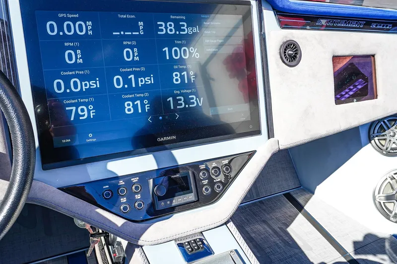 Slide: The Image of Dashboard of a 2026 Statement 396 boat with Garmin display showing engine metrics. - 34