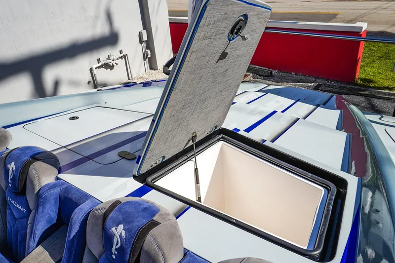 Slide: The Image of Open hatch on 2026 Statement 396 boat with blue and gray seating. - 41