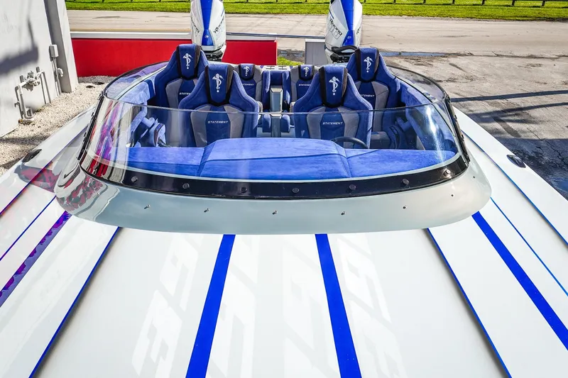 Slide: The Image of 2026 Statement 396 boat with blue-striped seats and sleek design. - 46