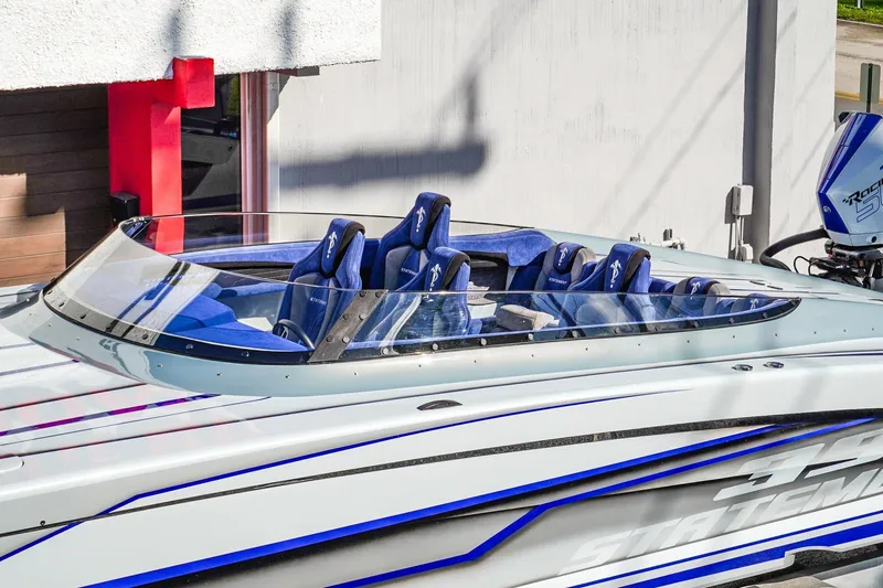 Slide: The Image of 2026 Statement 396 speedboat with blue seats and sleek design. - 5