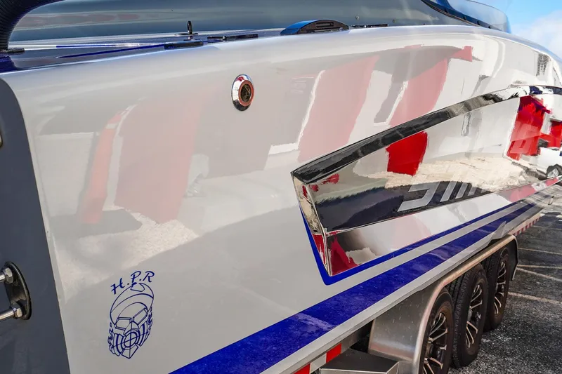 Slide: The Image of Sleek 2026 Statement 396 boat with reflective chrome accents and vibrant blue detailing. - 9