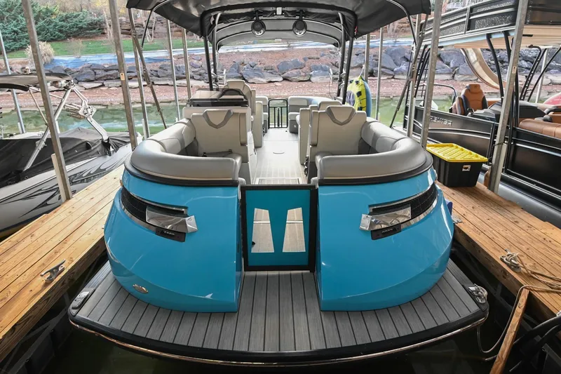 Slide: The Image of 2023 Montara 25 Monntara 2.0 boat docked, featuring sleek blue design and spacious seating. - 12
