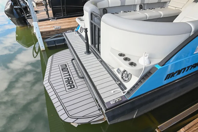 Slide: The Image of 2023 Montara 25 Monntara 2.0 boat with sleek deck and seating at dock. - 13