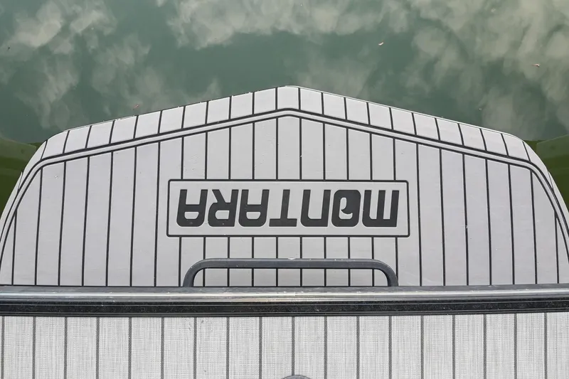 Slide: The Image of 2023 Montara 25 Monntara 2.0 boat deck with logo, reflecting on water. - 14