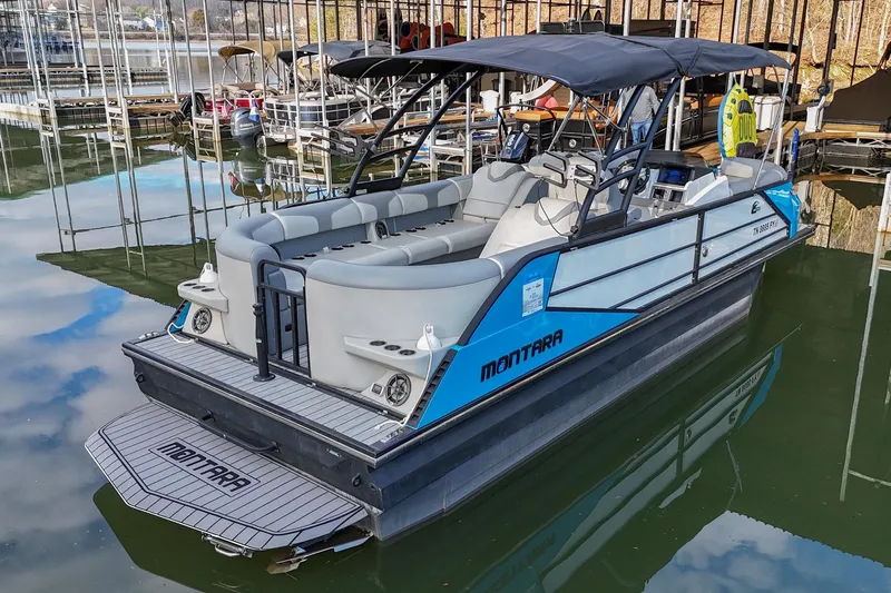 Slide: The Image of 2023 Montara 25 Monntara 2.0 boat docked, featuring sleek design and spacious seating. - 2