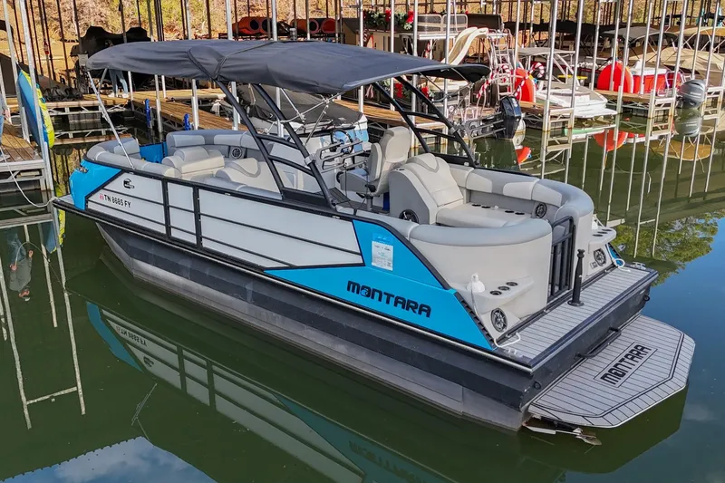 Slide: The Image of 2023 Montara 25 Monntara 2.0 boat docked, featuring sleek design and spacious seating. - 4