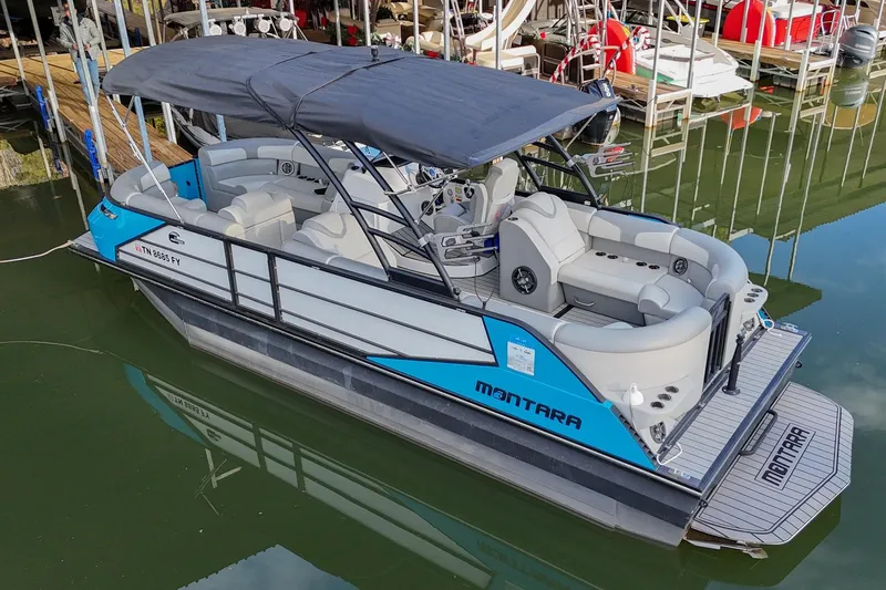 Slide: The Image of 2023 Montara 25 Monntara 2.0 boat docked, featuring sleek design and spacious seating. - 5