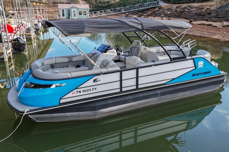 Slide: The Image of 2023 Montara 25 Montara 2.0 pontoon boat docked on calm water. - 7