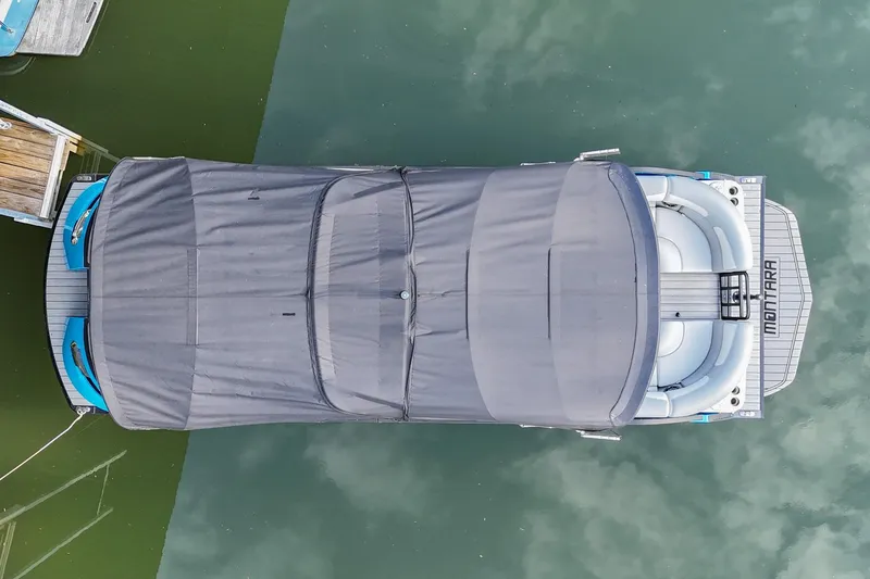 Slide: The Image of Aerial view of 2023 Montara 25 Monntara 2.0 boat with cover on water. - 8