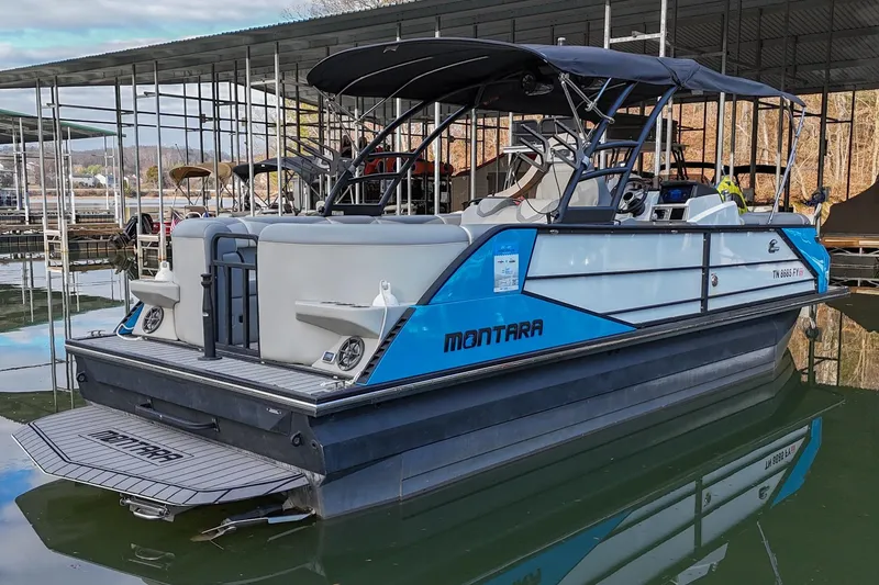 Slide: The Image of 2023 Montara 25 Monntara 2.0 boat docked, featuring sleek design and spacious seating. - 9