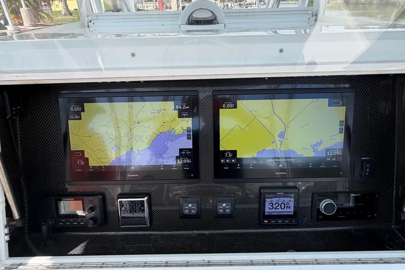 Slide: The Image of 2022 SeaHunter 38 CTS dashboard with dual Garmin navigation screens and controls. - 5