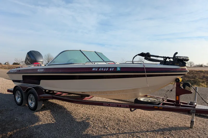 Slide: The Image of 2009 Skeeter SL1900 boat on trailer, parked outdoors under clear sky. - 10