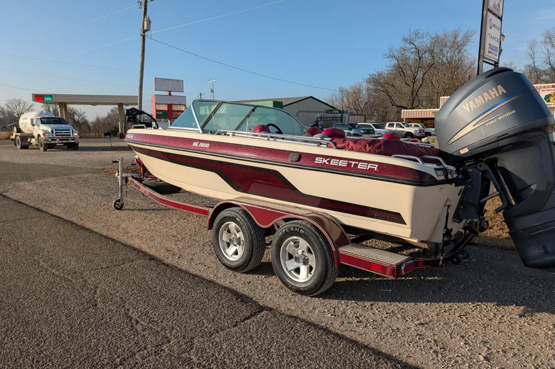 Slide: The Image of 2009 Skeeter SL1900 boat on trailer with Yamaha outboard motor in parking lot. - 4